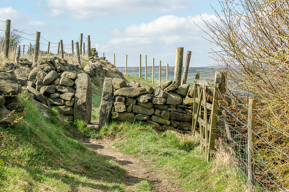 Stone stile on the Bronte Way alongside Leeming Reservoir